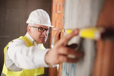 Man Working As Architect Measuring Wall In Construction Site Stock Photos