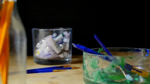 Man working as artist in art studio painting with brushes and using pencils  Stock Footage 85679367