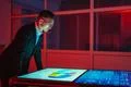 The man working with big displays in the dark room Photo