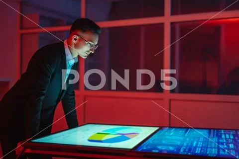 The man working with big displays in the dark room Stock Photos