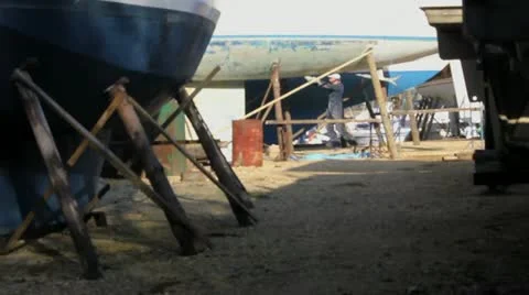 Man working on boat in yard Stock Footage 10882153