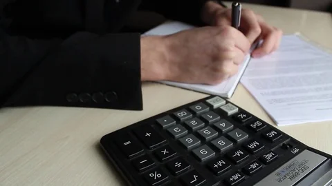 Man working with calculator Stock Footage 71614134