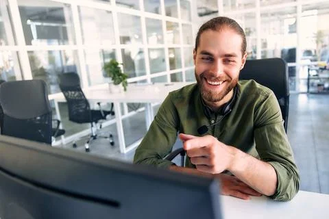 A man working as a call center operator in an office Stock Photos