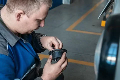 A man is working on a car engine Stock Photos