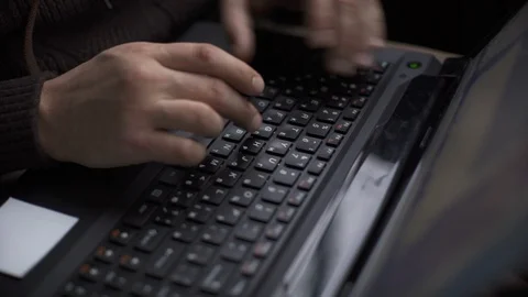 A man is working in a car typing text on a laptop Stock Footage 86519441