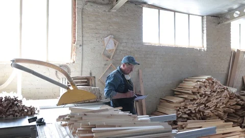 Man working as carpenter in his own woodshop. Stock Footage 128120189