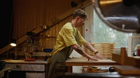 Man Working in Carpentry Workshop Assembling Wooden Product Stock Footage 340397904