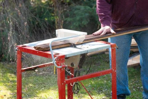 Man working with circular saw Stock Photos