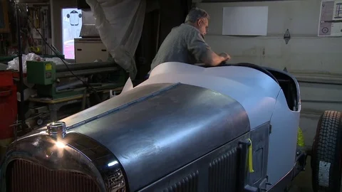 Man working on a classic hot rod Stock Footage 74130984