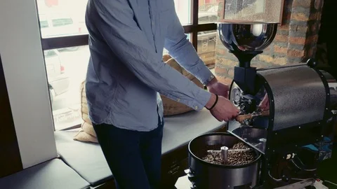 Man working with coffee beans roasting machine Stock Footage 95911415