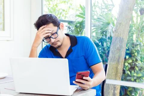 A man working on computer and having headache Stock Photos