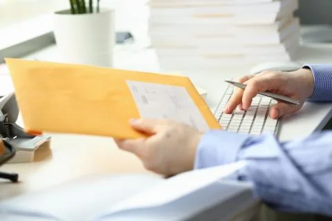 Man working with computer and papers in office Stock Photos