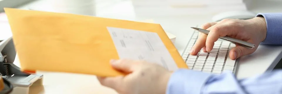 Man working with computer and papers in office Stock Photos