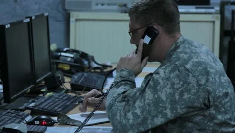 Man working on computer and talking on phone (HD)m Stock Footage 11435977