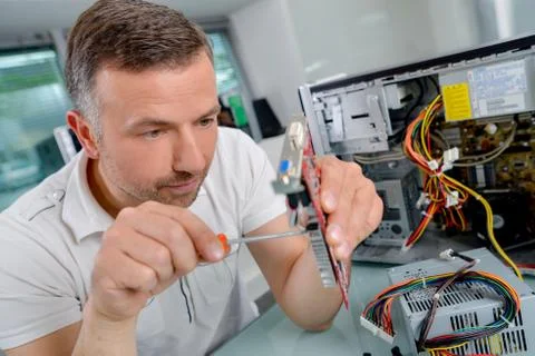 Man working on computer component Stock Photos