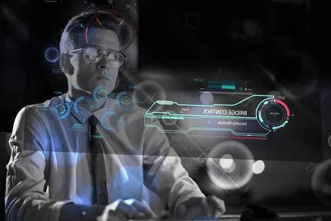 Man working on computer in dark office Young man working on computer at ni... Stock-Fotos