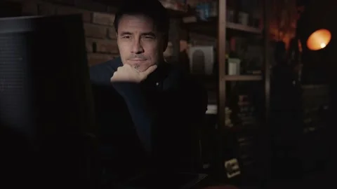 Man working on computer in dark room at home Stock Footage 131852466