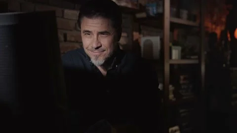 Man working on computer in dark room at home Stock Footage 148433260