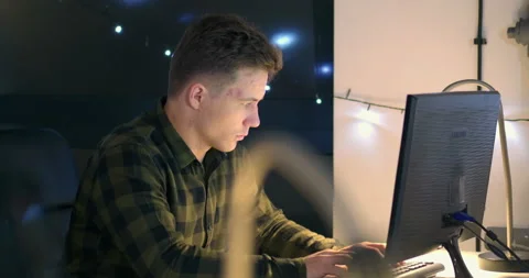 Man working on computer at desk at night Video stock 144270777