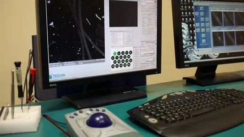 Man is working on computer with electronic miscroscope and human hair Stock Footage 76701281