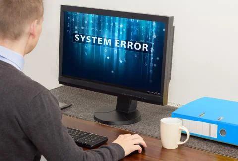 Man working on computer with error Stock Photos