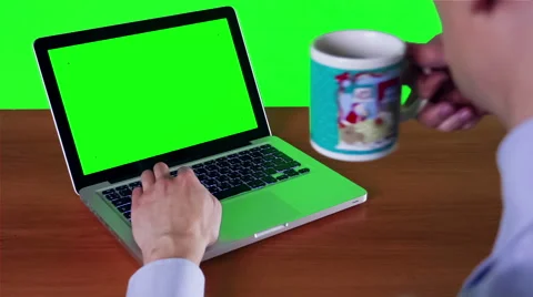 A Man Working At A Computer With A Green Screen Stockbeeldmateriaal 49669186