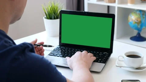 Man working on a computer, green screen. Over the shoulder shot Stock Footage 104173550