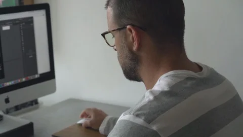 Man working on a computer at home 動画素材 127906524