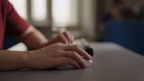 Man working on computer at home office desk. Close-up shot of hands typing on Stock Footage 348070226
