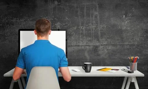 Man working on computer with isolated screen in office interior. Stock Photos