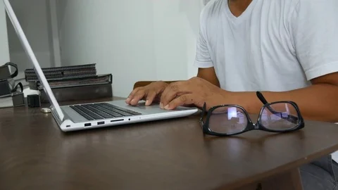 A man working with computer laptop on work desk Stock Footage 80125584