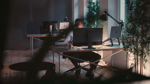 Man Working on Computer in a Modern Office Environment Stock Footage 307762547