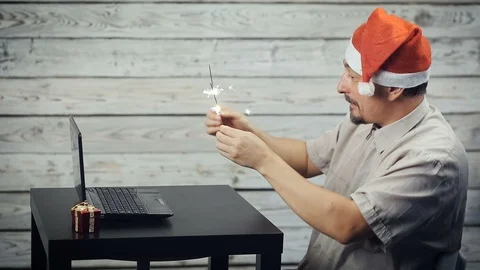 A man working at a computer in the new year Видео 98334078