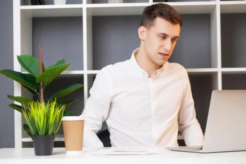 Man working at the computer in the office and filling documents Stock Photos
