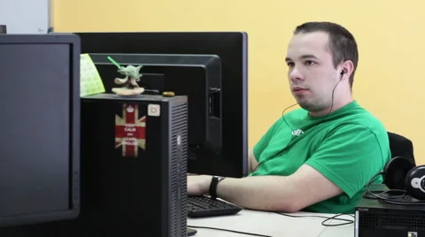 A man working at a computer in the office Stock Footage 61145984