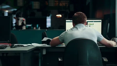 A man is working at a computer in the office Stock Footage 76130828