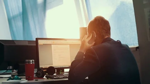 A man is working at a computer in the office Stock Footage 76130842