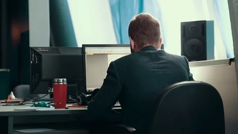 A man is working at a computer in the office Stock Footage 76130874