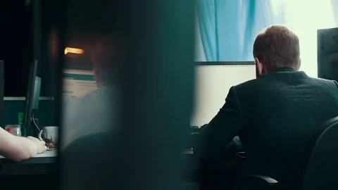 A man is working at a computer in the office Stock Footage 76130894