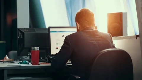 A man is working at a computer in the office Stock Footage 76130993