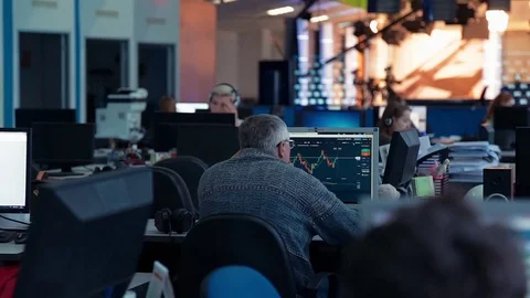 A man is working at a computer in the office 動画素材 76400482