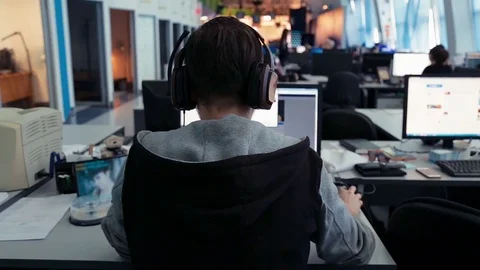 A man is working at a computer in the office Stock Footage 76400608
