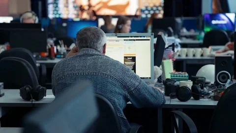 A man is working at a computer in the office Stock Footage 76400662