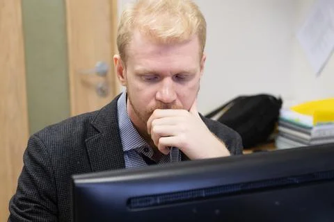 A man is working at a computer Stock Photos