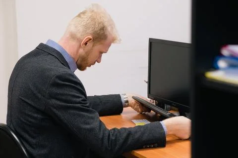 A man is working at a computer Stock Photos