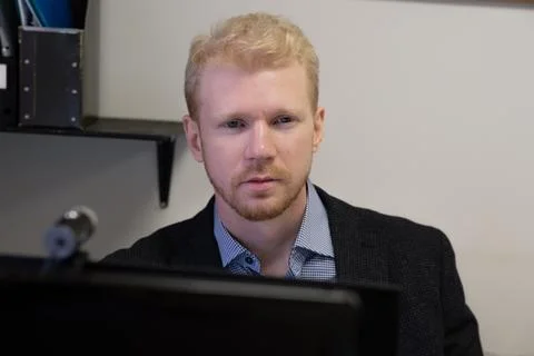 A man is working at a computer Stock Photos