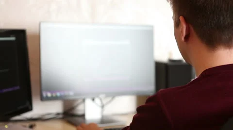 A man working at a computer programmer. Testing the program code Stock Footage 63421215