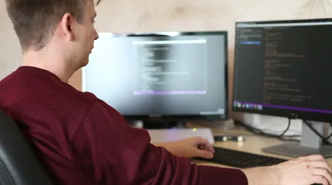 A man working at a computer programmer. Testing the program code Stock Footage 63421217
