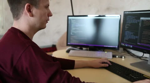 A man working at a computer programmer. Testing the program code Stock Footage 63421226