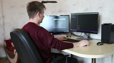 A man working at a computer programmer. Testing the program code Stock Footage 63421227